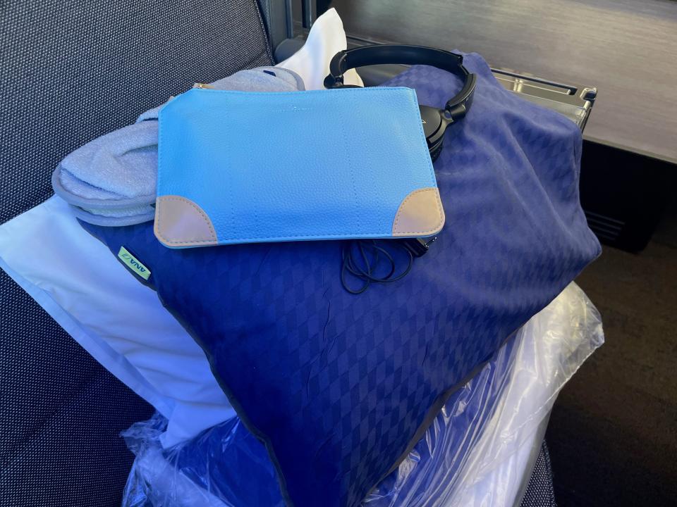 The amenity kit and linens on "The Room" on ANA.