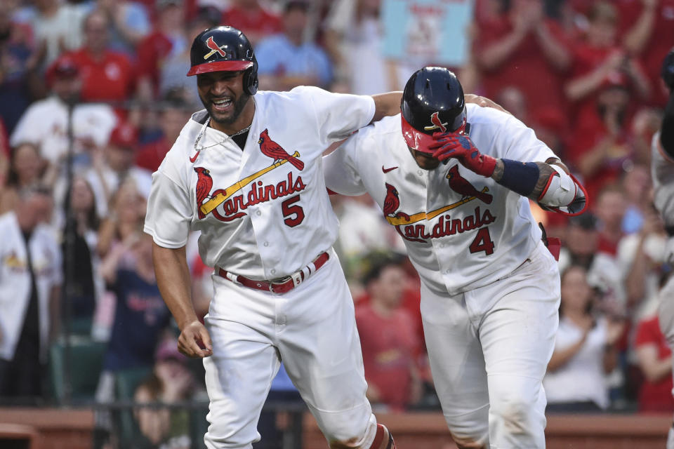 St. Louis Cardinals' Yadier Molina (4), right, celebrates with teammate Albert Pujols after hitting a two run home run during the fifth inning of a baseball game against the San Francisco Giants on Sunday, May 15, 2022, in St. Louis. (AP Photo/Joe Puetz)