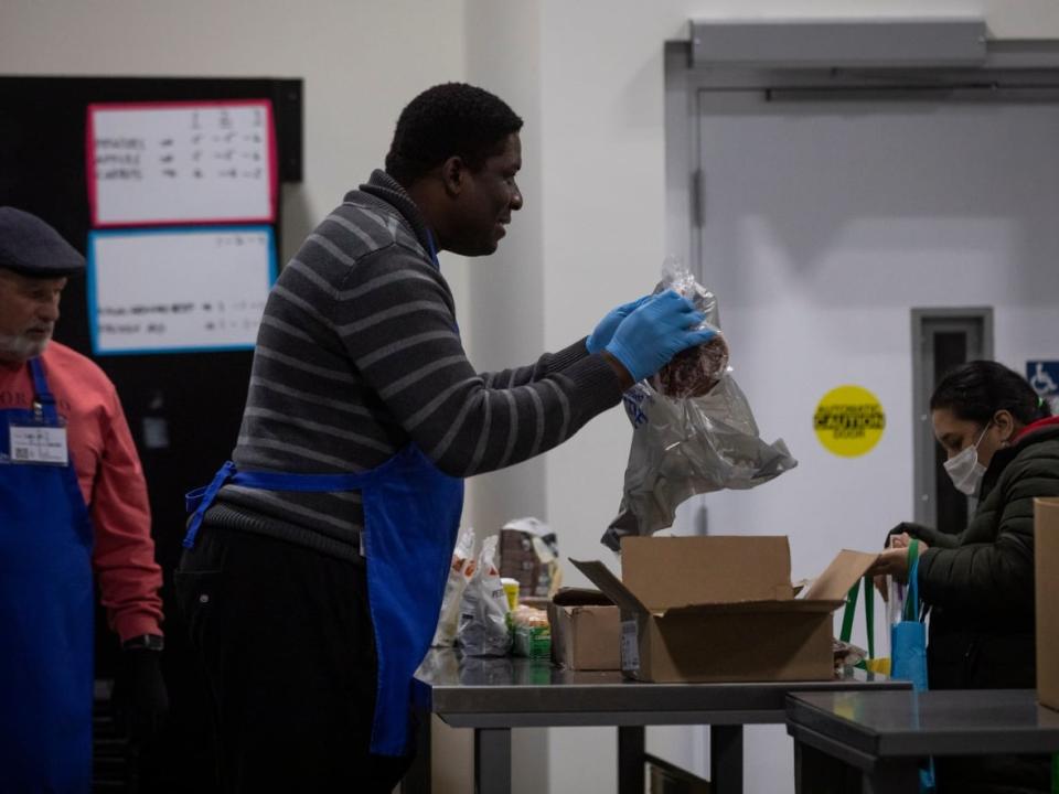 People are pictured at the Surrey Food Bank in Surrey, B.C., on Nov. 24.  (Ben Nelms/CBC - image credit)