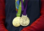 2016 Rio Olympics - Boxing - Victory Ceremony - Women's Middle (75kg) Victory Ceremony - Riocentro - Pavilion 6 - Rio de Janeiro, Brazil - 21/08/2016. Gold medallist Claressa Shields (USA) of USA poses with her medals from Rio 2016 and London 2012. REUTERS/Peter Cziborra