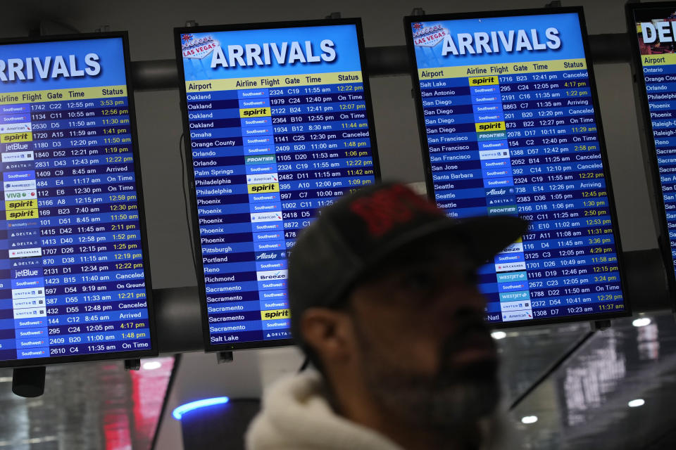 Flight status boards show delayed and cancelled flights at Harry Reid International Airport, Wednesday, Jan. 11, 2023, in Las Vegas. Delays and cancellations among flights across the United States were minimal on Thursday, a day after a system that offers safety information to pilots failed, grounding some planes for hours. (AP Photo/John Locher)