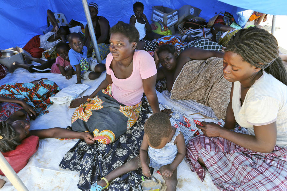 Families are seen inside a tent at a camp for displaced survivors of cyclone Idai in Beira, Mozambique, Tuesday, April, 2, 2019. Mozambican and international health workers raced Monday to contain a cholera outbreak in the cyclone-hit city of Beira and surrounding areas, where the number of cases has jumped to more than 1,000. (AP Photo/Tsvangirayi Mukwazhi)