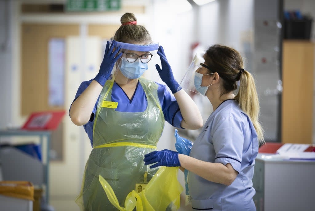 Nurses changing their PPE as departing Sage member Sir Jeremy Farrar warns that virus levels are still concerning (Jane Barlow/PA) (PA Wire)