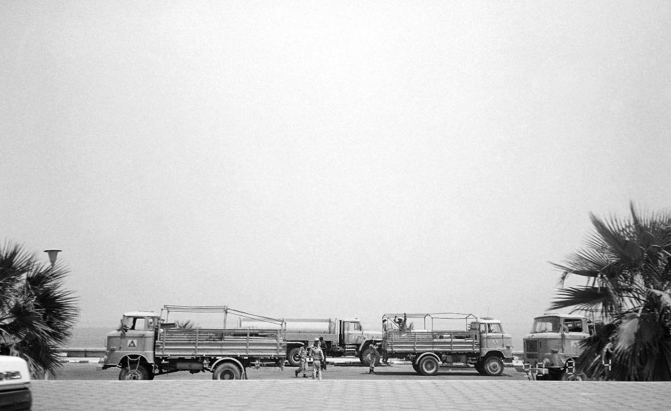 FILE - In this Aug. 4, 1990 file photo, Iraqi soldiers get off the back of a troop carrier along the beachfront area in Kuwait City, two days after the invasion of Kuwait by Iraq. Saddam Hussein's army rolled into his tiny Gulf neighbor in August 1990, deposed the Kuwaiti royal family, who fled to Saudi Arabia, and declared the country Iraq's 19th province. (AP Photo/Stephanie McGehee, File)