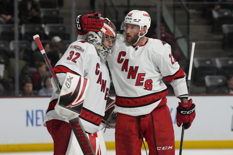 Carolina Hurricanes goaltender Antti Raanta (32) and right wing Stefan Noesen celebrate the team's win 6-1 win over the Arizona Coyotes in an NHL hockey game Friday, March 3, 2023, in Tempe, Ariz. (AP Photo/Rick Scuteri)