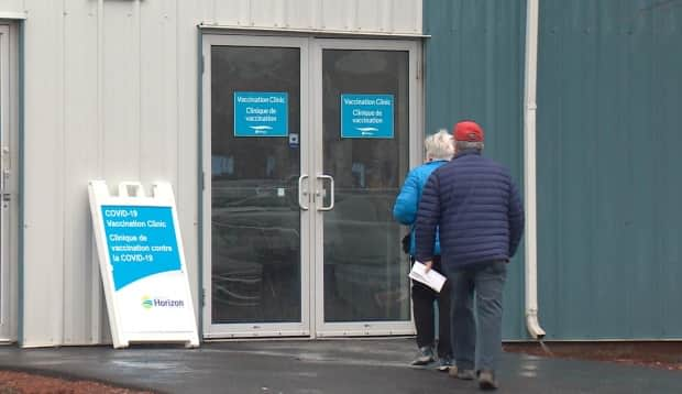 Residents arrive to get their AstraZeneca-Oxford vaccine at the Exhibition Park site in Saint John on Thursday. The clinic, for people 55 and over, was booked within two-and-a-half hours of being announced Tuesday, with 240 people signing up for shots. (Roger Cosman/CBC News - image credit)