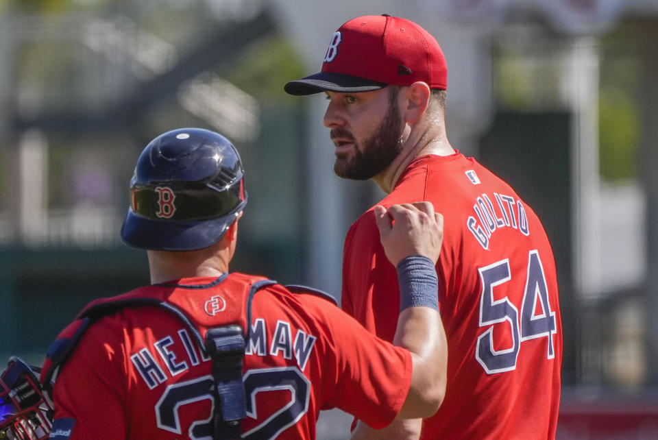 Red Sox pitcher Lucas Giolito (54) walks with catcher Tyler Heineman (32) during spring training in Fort Myers, Fla., Thursday, Feb. 15, 2024. (AP Photo/Gerald Herbert)