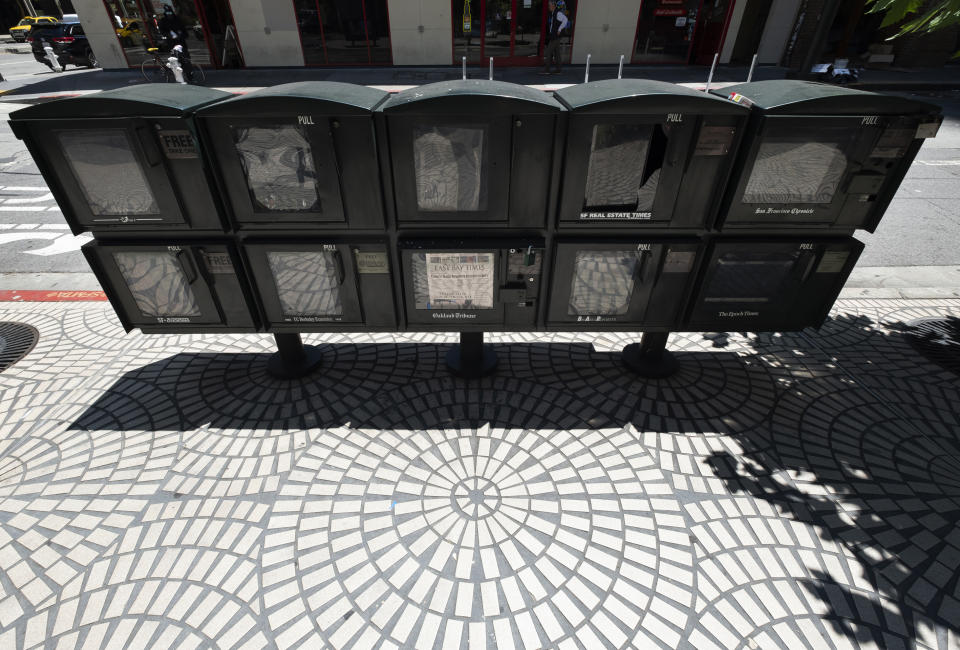 In this July 5, 2019, photo, an East Bay Times newspaper sits in the bottom row of empty news racks in the Financial District in San Francisco. Ownership changes and consolidations have left the region known as the East Bay with just a single daily newspaper. The East Bay Times, based in Walnut Creek, attempts to cover a region nearly the size of Delaware with a fraction of the staff of the former dailies. (AP Photo/Eric Risberg)