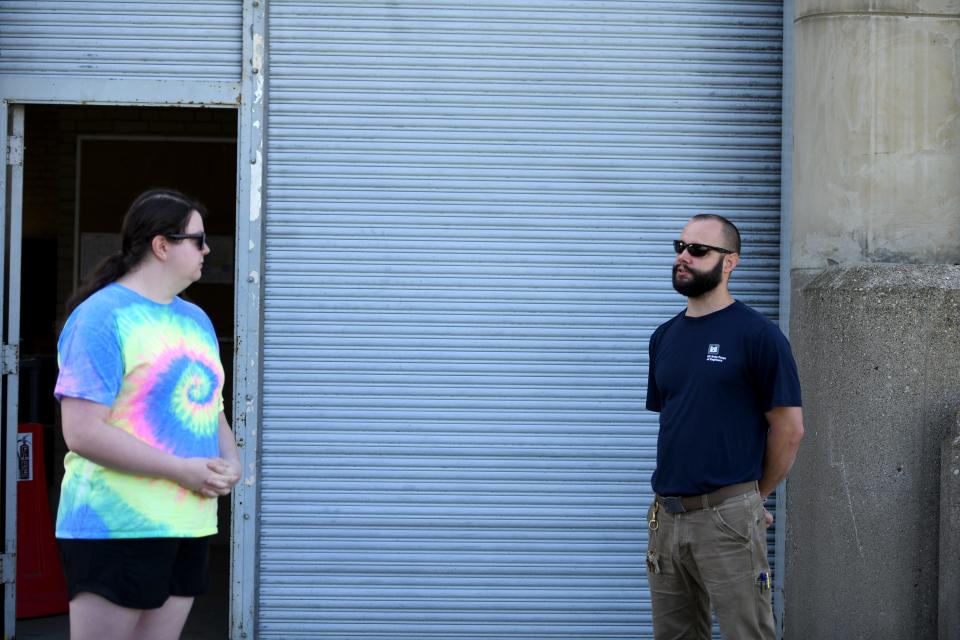 Katie Carpenter of Dover speaks with Matt Calder, the Bolivar Dam tender with U.S. Army Corps of Engineers, during a visit to the dam Saturday.