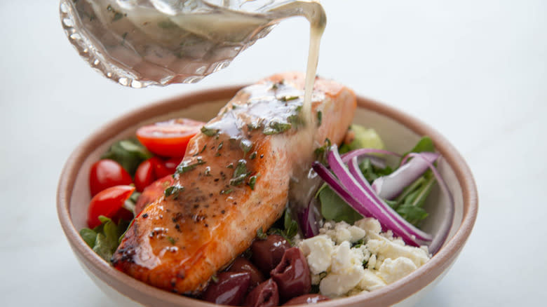 pouring dressing on salad