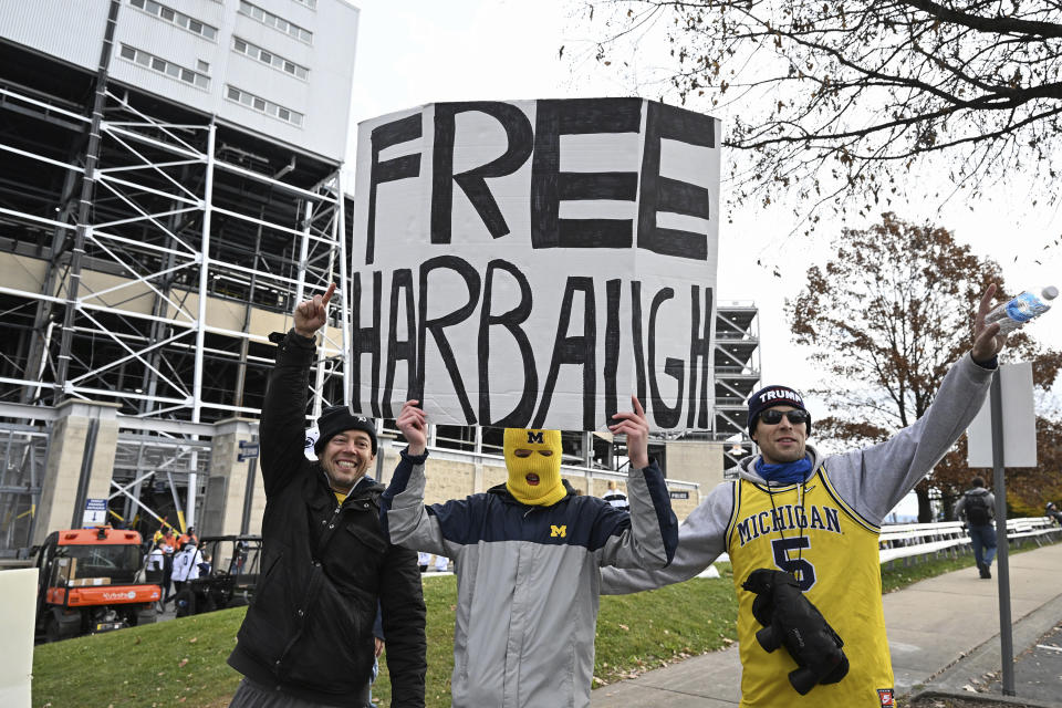Fans display a sign about Michigan head coach Jim Harbaugh outside of Beaver Stadium before an NCAA college football game against Penn State, Saturday, Nov. 11, 2023, in State College, Pa. (AP Photo/Barry Reeger)