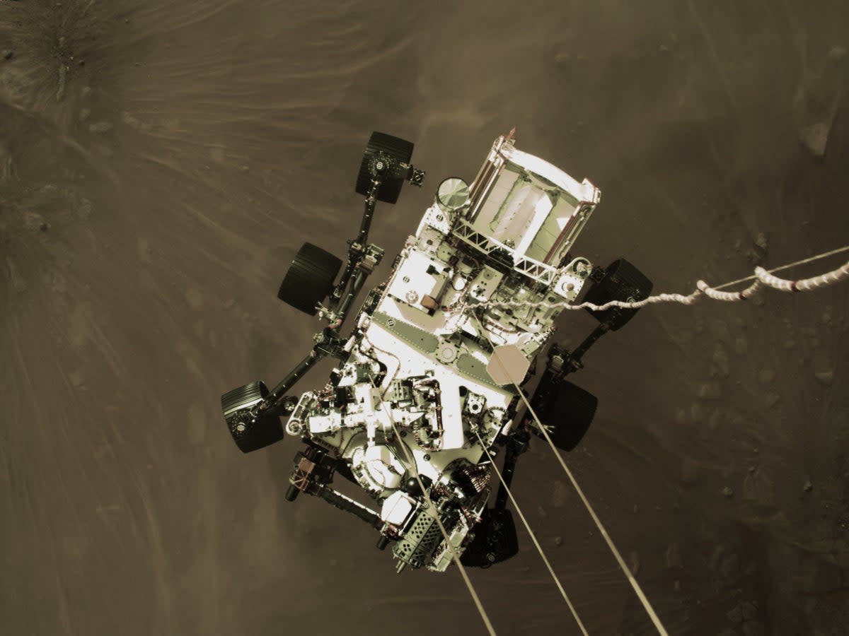 The Mars Perseverance rover moments before it touched down on the planet (Nasa/PA) (PA Media)