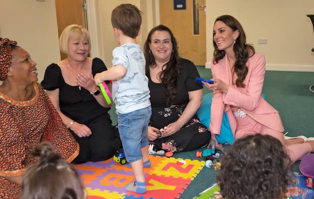 <p>Eddie Mulholland - WPA Pool/Getty</p> Catherine, Princess of Wales talks with Kinship Carers and children at Saint Pancras Community Association in May 2023.