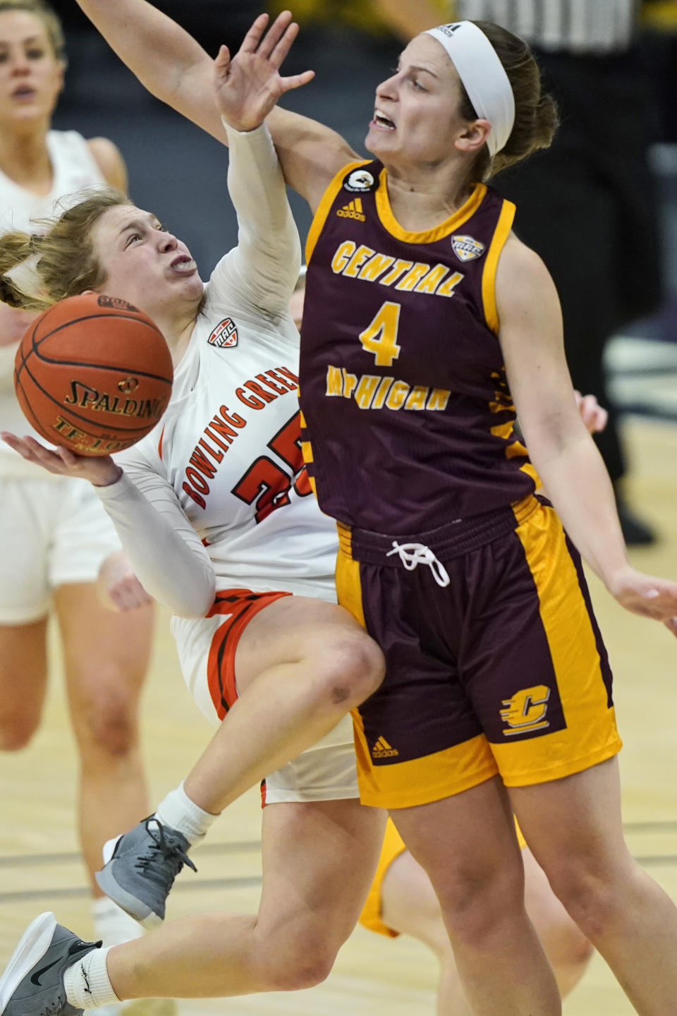 Bowling Green's Lexi Fleming (25) is stopped by Central Michigan's Maddy Watters (4) during the second half of an NCAA college basketball game in the championship of the Mid-American Conference tournament, Saturday, March 13, 2021, in Cleveland. Central Michigan won 77-72. (AP Photo/Tony Dejak)