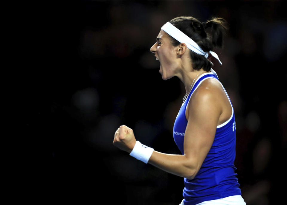 France's Caroline Garcia celebrates a point during the Billie Jean King Cup qualifying match at the Coventry Building Society Arena, Coventry, Britain, Friday April 14, 2023. (Bradley Collyer/PA via AP)