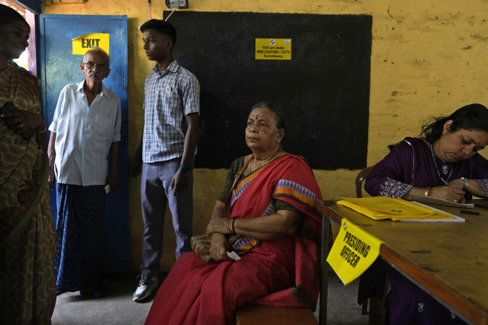 A woman waits to cast her vote at a polling booth during the second round of voting in the six-week-long national election near Palakkad, in Indian southern state of Kerala, Friday, April 26, 2024. (AP Photo/Manish Swarup)