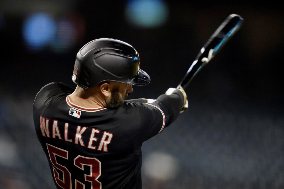 Arizona Diamondbacks' Christian Walker follows through on a solo home run against the Atlanta Braves during the eighth inning of a baseball game, Wednesday, Sept. 22, 2021, in Phoenix. (AP Photo/Matt York)