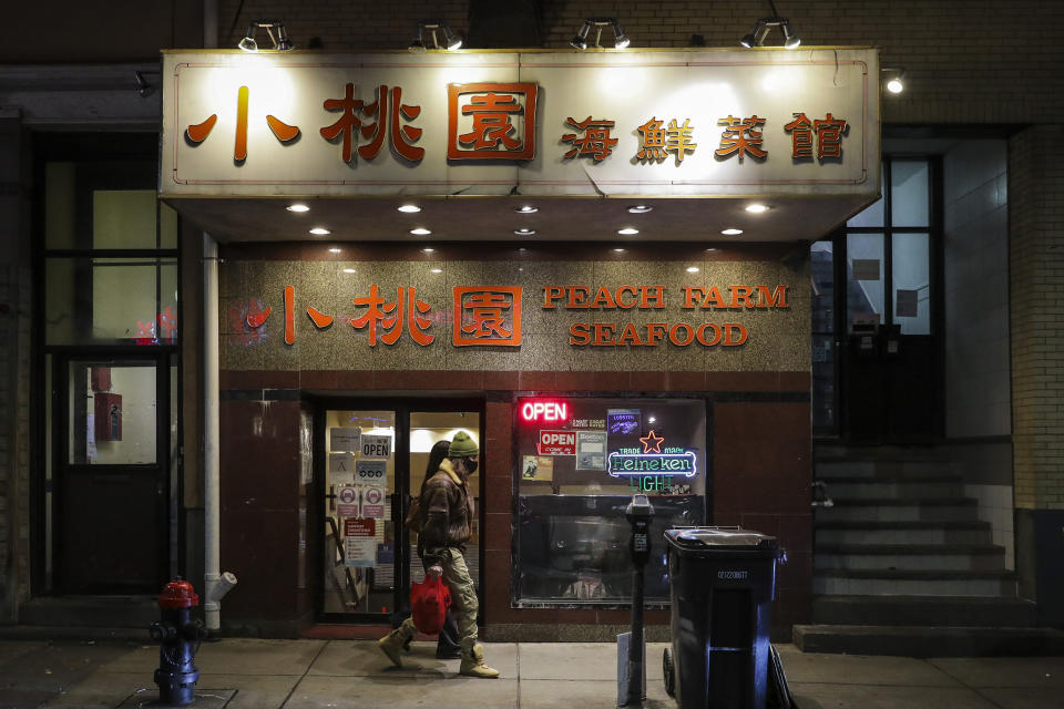 Pedestrians walk past Peach Farm in Boston's Chinatown on Jan. 15, 2021.  (Erin Clark / Boston Globe via Getty Images file)