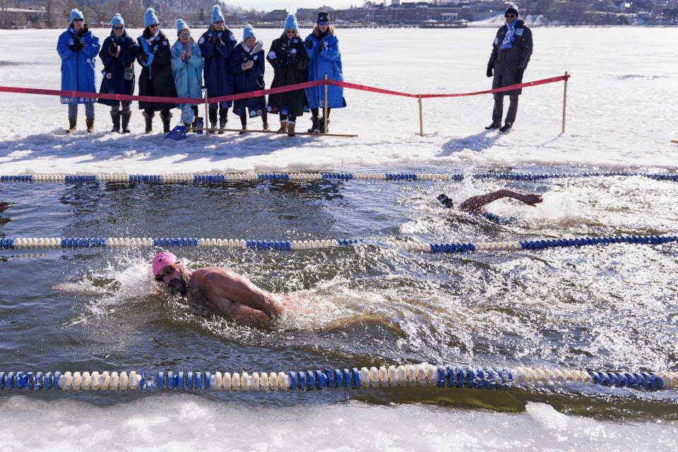 Athletes race during the 200 meter freestyle competition during the winter swimming festival on frozen Lake Memphremagog, Friday, Feb. 23, 2024, in Newport, Vermont. (AP Photo/Charles Krupa)