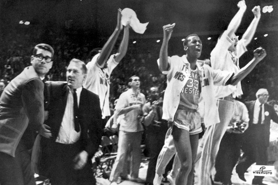 FILE - Texas Western basketball coach Don Haskins, second from left, and players celebrate after winning the NCAA college basketball championship against Kentucky in College Park, Md., March 19, 1966. Texas Western was the first all-Black starting five to win an NCAA title. (AP Photo/File)