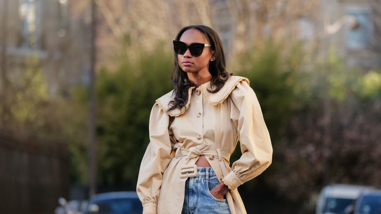 Woman wearing a trench coat with jeans 