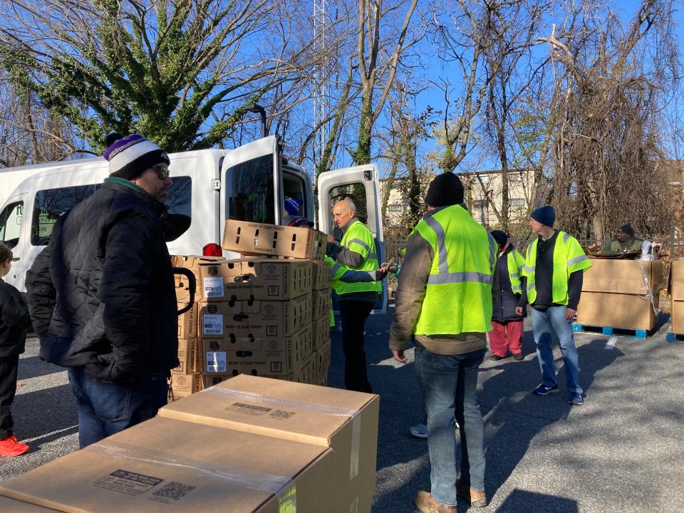 Volunteers gathered to give out over 600 turkeys and other Thanksgiving foods to those in need outside the Woodlawn Library in Wilmington on Nov. 19, 2022.