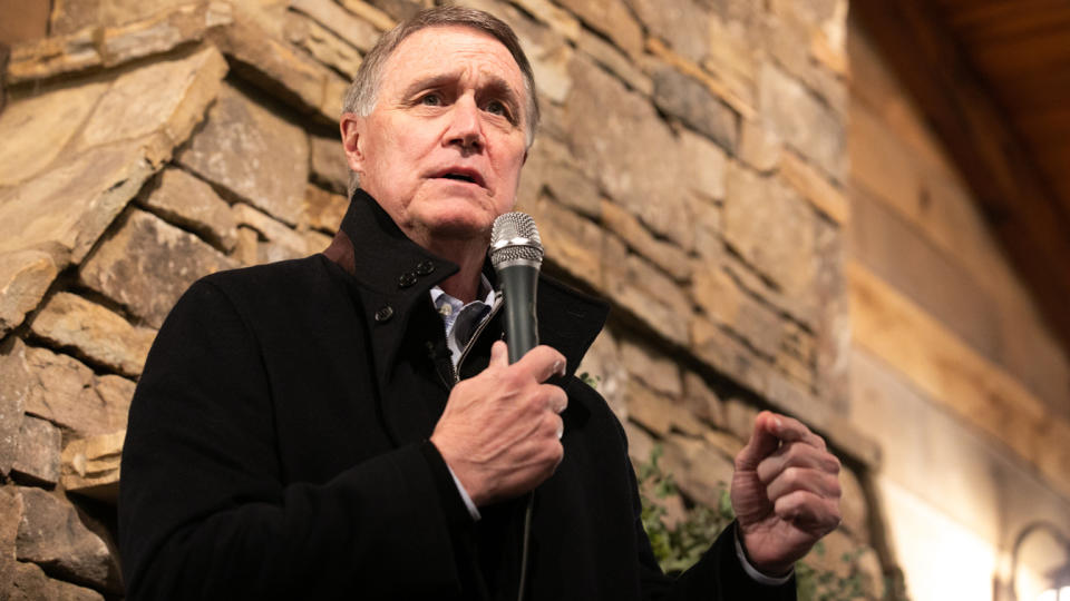 Then-Sen. David Perdue, R-Ga., holds a microphone as he speaks at a campaign rally in December 2020.