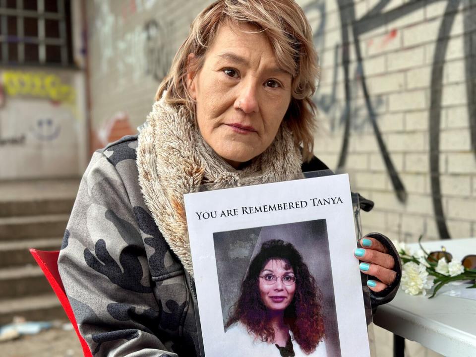 Vanessa Brooks holds a picture of her sister, Tanya Brooks, on the fifteenth anniversary of her death.