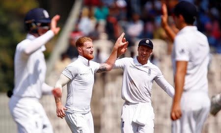 Cricket - India v England - Fifth Test cricket match - M A Chidambaram Stadium, Chennai, India - 18/12/16. England's Ben Stokes (2nd L) celebrates with team mate Jos Buttler (2nd R) after the dismissal of India's Cheteshwar Pujara. REUTERS/Danish Siddiqui