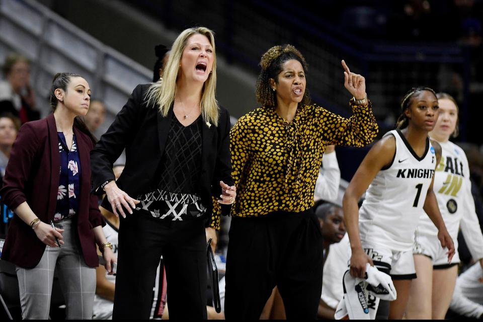 Central Florida head coach Katie Abrahamson-Henderson, left, and assistant coach Nykesha Sales react during the second half of a first-round women's college basketball game against Florida in the NCAA tournament, Saturday, March 19, 2022, in Storrs, Conn. (AP Photo/Jessica Hill)