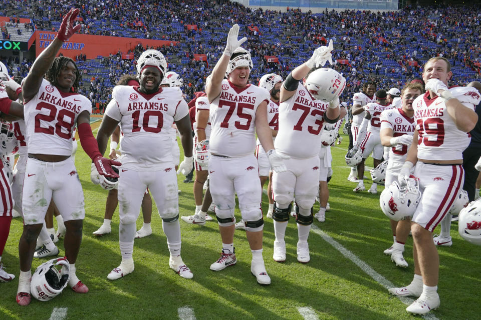 Arkansas players celebrate in front of their school band after defeating Florida in an NCAA college football game, Saturday, Nov. 4, 2023, in Gainesville, Fla. (AP Photo/John Raoux)