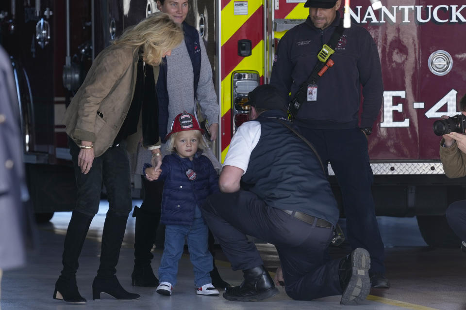 First Lady Jill Biden, left, holds the hand of her grandson Beau Biden, as they and President Joe Biden visit with firefighters on Thanksgiving Day at the Nantucket Fire Department in Nantucket, Mass., Thursday, Nov. 24, 2022. (AP Photo/Susan Walsh)