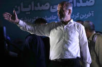 Reformist candidate for the Iran's presidential election Masoud Pezeshkian waves to his supporters during a campaign rally in Tehran, Iran, Wednesday, July 3, 2024. Comments suggesting that Iran's reformist presidential candidate could increase government-set gasoline prices have raised fears of a repeat of nationwide protests. (AP Photo/Vahid Salemi)