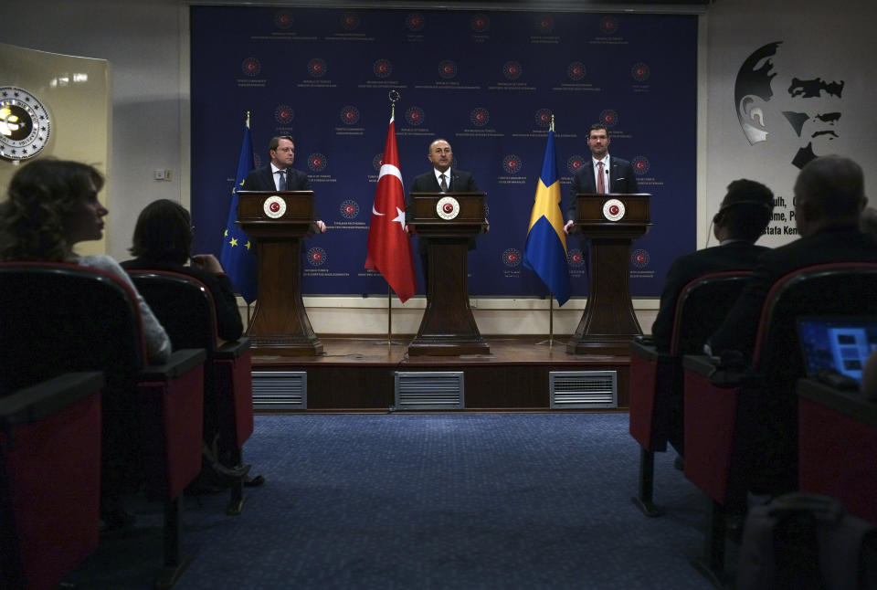 Turkey's Foreign Minister Mevlut Cavusoglu, centre, European Commissioner for Neighbourhood and Enlargement Oliver Varhelyi, left, and Sweden's Minister for International Development Cooperation and Foreign Trade Johan Forssell speak at a joint news conference in Ankara, Turkey, Wednesday, Feb. 22, 2023. Varhelyi and Forssell are in town to prepare for the International Donor's Conference, scheduled for March in Brussels, and aimed at mobilizing funds from the international community to support Turkey and Syria following the quakes.(AP Photo/Burhan Ozbilici)