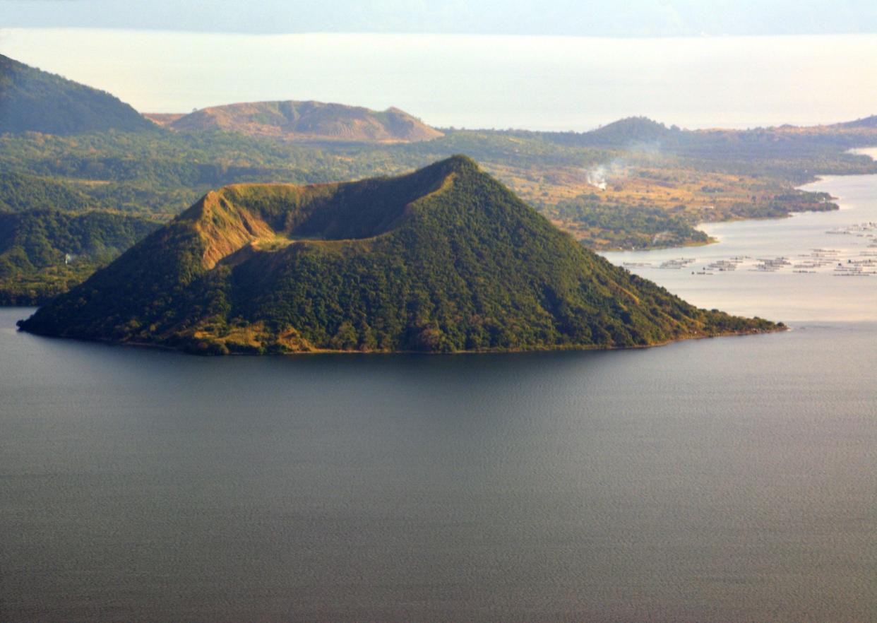Stunning volcanic landscape of lake Taal from Tagaytay, a village located on the huge caldera, who forms the lake. The large volcanic caldera was formed by very large eruptions between 500,000 and 100,000 years ago.