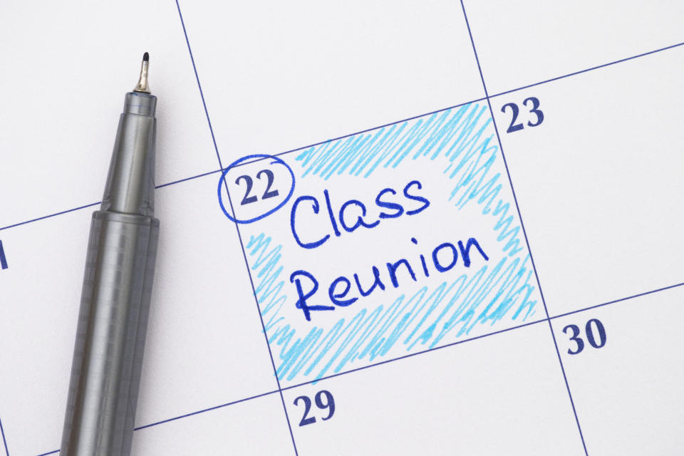 Close-up of a calendar marking "Class Reunion" on the 22nd, with a pen nearby