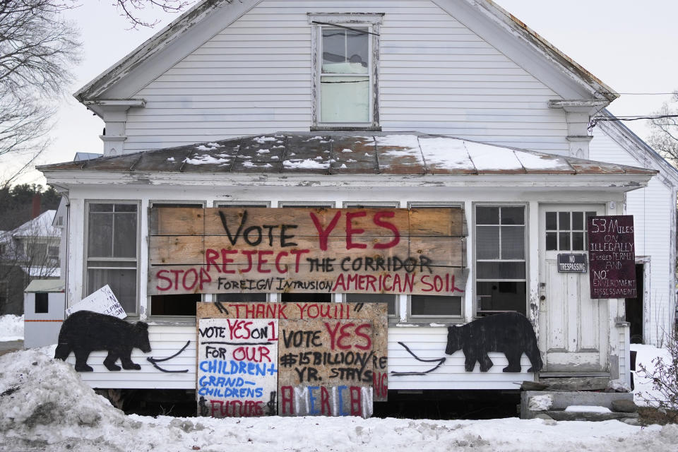 FILE - In this Oct. 27, 2022 file photo, a home in Bingham, Maine, displays signs protesting a Quebec-to-New England hydropower corridor. This fall Mainers are going to vote on whether to throw out the state's two biggest private electric utilities. (AP Photo/Robert F. Bukaty, files)