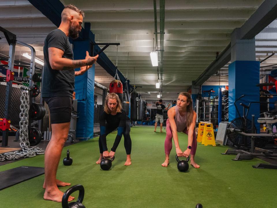Rachel learning to kettlebell swing with Jay and Steph Rose.