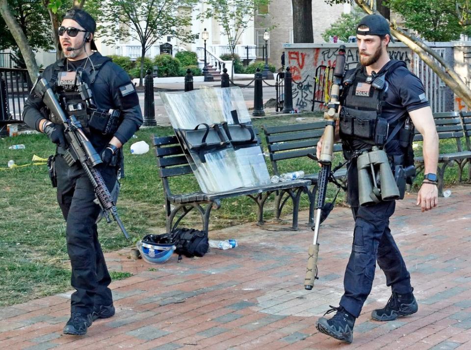 USSS counter-snipers armed with an SR-25-series semi-automatic rifle, at left, and a bolt-action rifle related to the US Marine Corps Mk 13 Mod 7, at right. <em>AP Photo/Patrick Semansky</em>