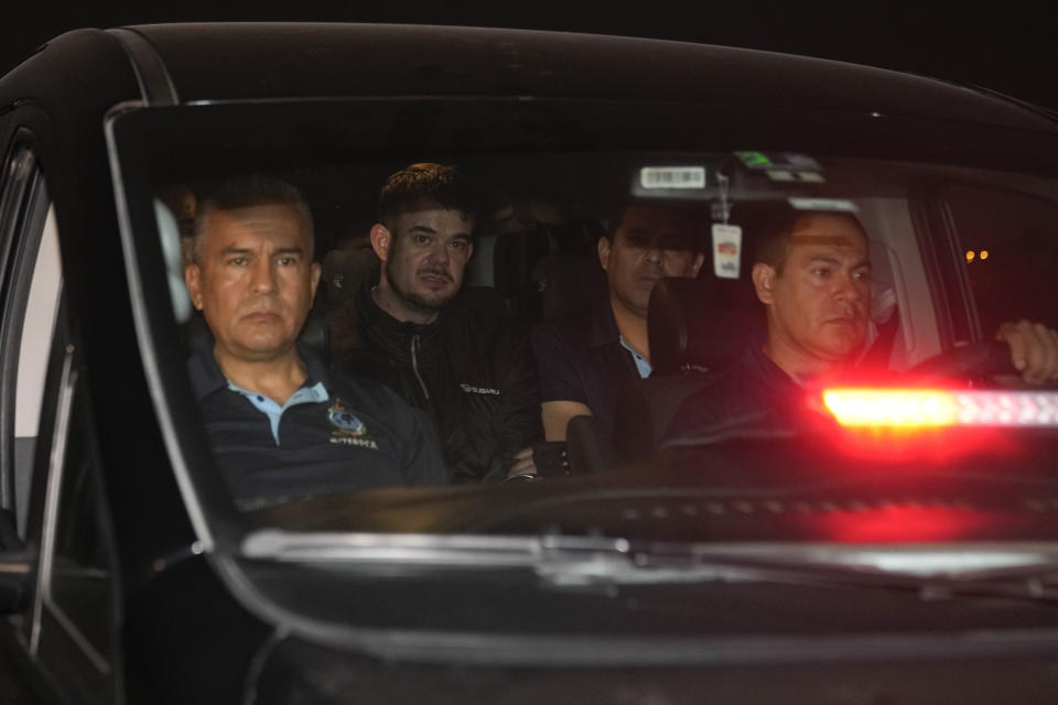 Dutch citizen Joran van der Sloot, back left, is driven in a police vehicle from the Ancon I maximum-security prison, outskirts of Lima, Peru, Thursday, June 8, 2023. The main suspect in the unsolved 2005 disappearance of American student Natalee Holloway on the Caribbean island of Aruba is expected to be extradited Thursday from Peru to the United States. .(AP Photo/Martin Mejia)