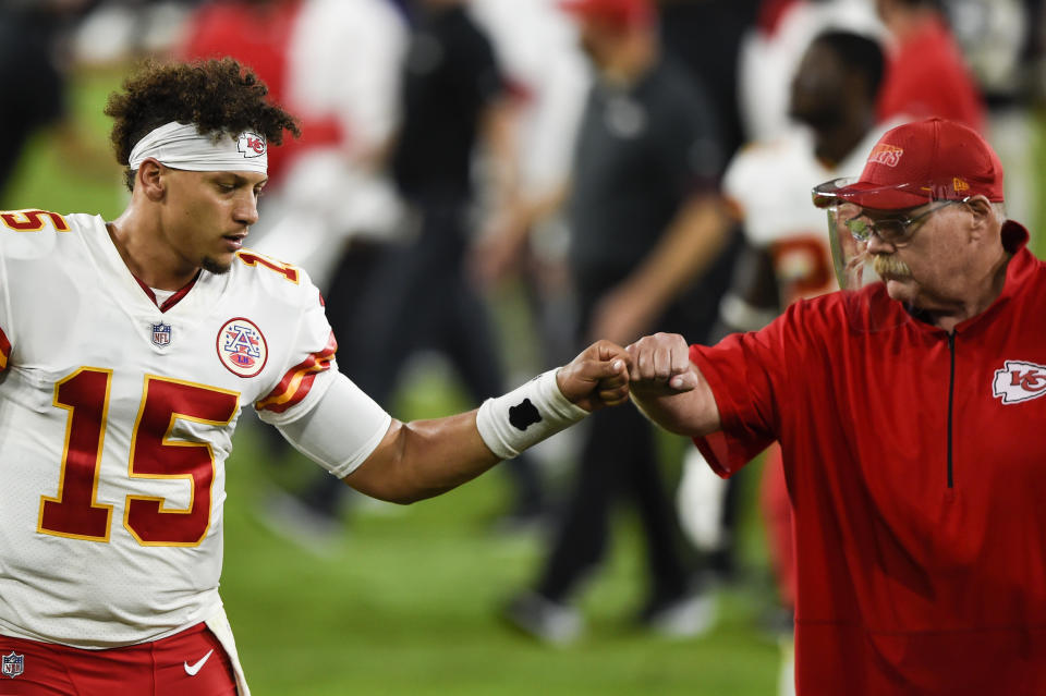 Chiefs quarterback Patrick Mahomes and head coach Andy Reid bump fists.