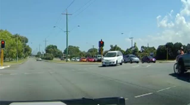 A 4WD strikes the cyclist (to the right of the screen), causing him to fall off his bike. Source: Dash Cam Owners Australia Facebook