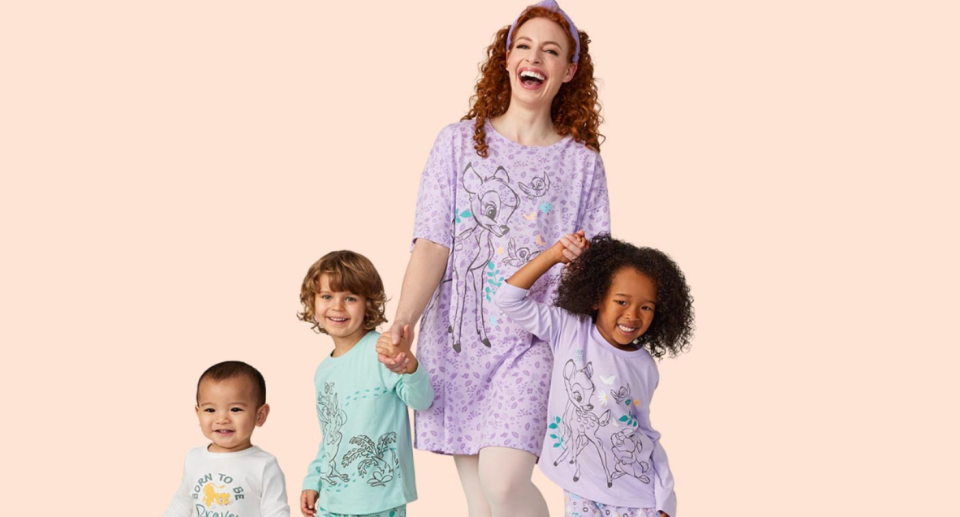 Emma Watkins poses in pyjamas with children.