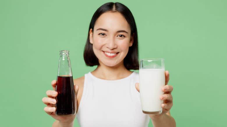 Woman holding soda and milk