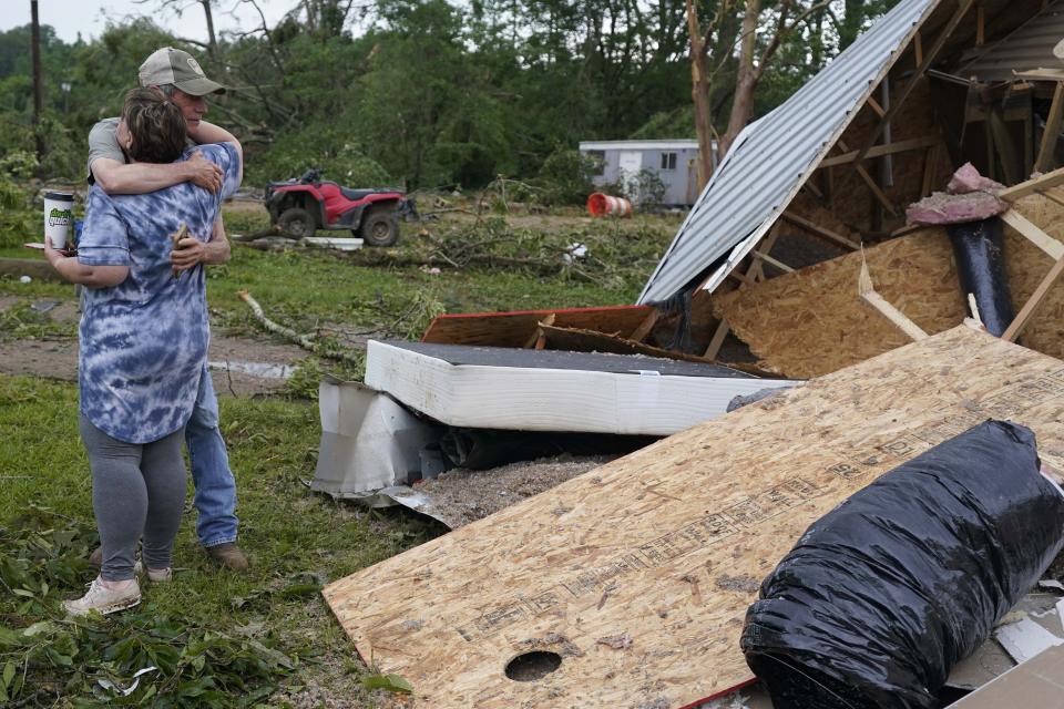 A neighbor hugs Vickie Savell next to the remains of her new mobile home early Monday, May 3, 2021, in Yazoo County, Miss. Multiple tornadoes were reported across Mississippi on Sunday, causing some damage but no immediate word of injuries. (AP Photo/Rogelio V. Solis)