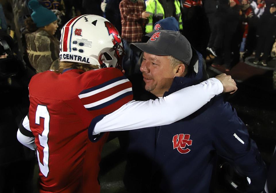 West Central's Bryce Bigger (3) hugs head coach Jason Kirby during the celebration of the 44-36 victory in the Illinois 8-player championship against Amboy Friday in Monmouth, Illinois.