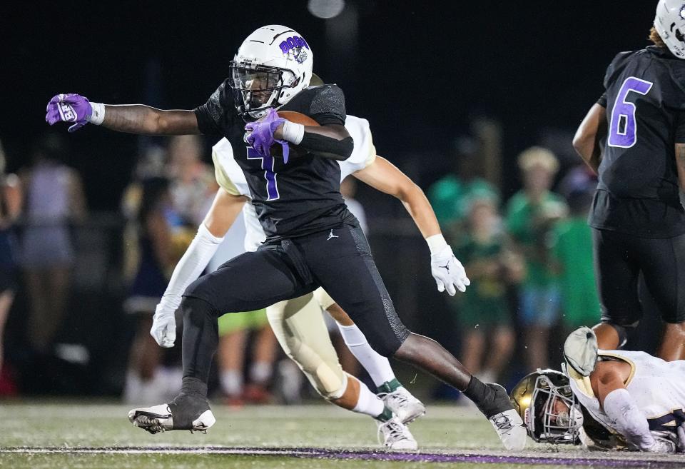 Brownsburg Bulldogs running back Garrett Sherrell (7) rushes up the field Friday, Aug. 25, 2023, during the game against the Cathedral Fighting Irish at Brownsburg High School in Brownsburg. The Brownsburg Bulldogs defeated the Cathedral Fighting Irish, 45-31.