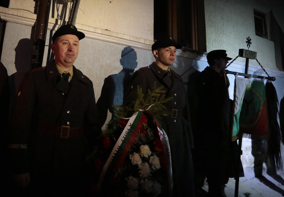 Bulgarian far-right nationalists observe a minute of silence in front of the house of Gen. Hristo Lukov, known for his anti-Semitic and pro-Nazi activities in Sofia, Saturday, Feb., 15 2014. Hundreds of Bulgarian nationalists have marched through the capital to honor a World War II general known for his anti-Semitic and pro-Nazi activities, although Sofia's mayor had banned Saturday's rally, organized by the far-right Bulgarian National Union. (AP Photo/Valentina Petrova)