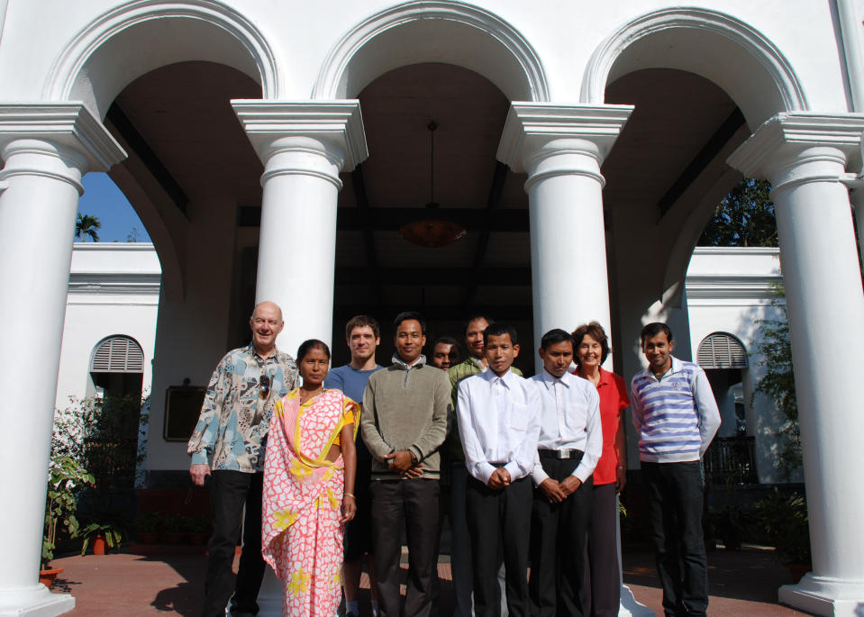 In this photo taken Nov. 29, 2012, guests and staff members pose at the entrance of Thengal Manor, gracious home of the Barooah tea dynasty which is now open to tourists in Jorhat, India. Guests enjoy superb service from a staff of 15 for only five rooms. (AP Photo/Denis Gray)