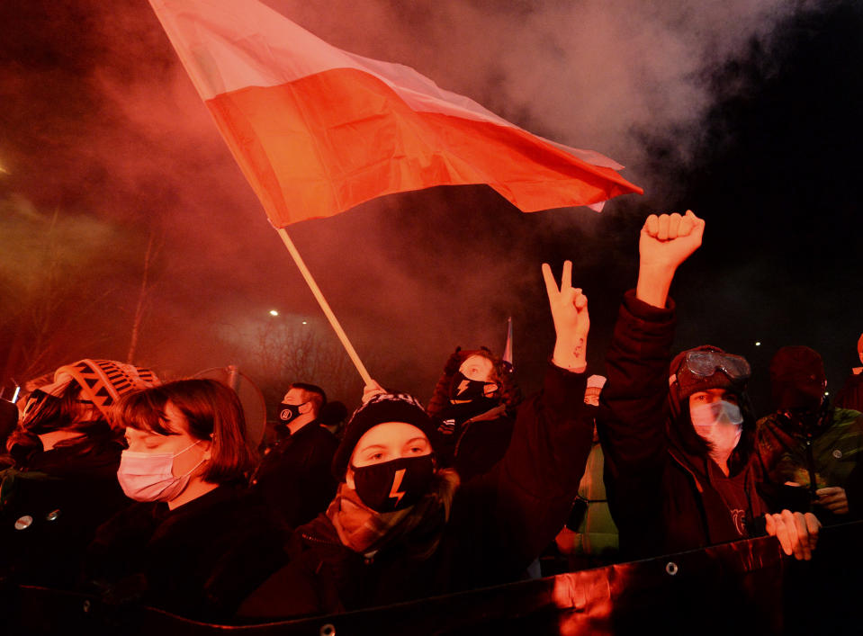 People protest against new anti-abortion laws, near the ruling Law and Justice party headquarters in Warsaw, Poland Wednesday Jan. 27, 2021, to protest after the country's top court on Wednesday confirmed its highly divisive ruling that will further tighten the predominantly Catholic nation's strict anti-abortion law. The Constitutional Tribunal published the justification of its decision, which will take immediate effect.(AP Photo/Czarek Sokolowski)